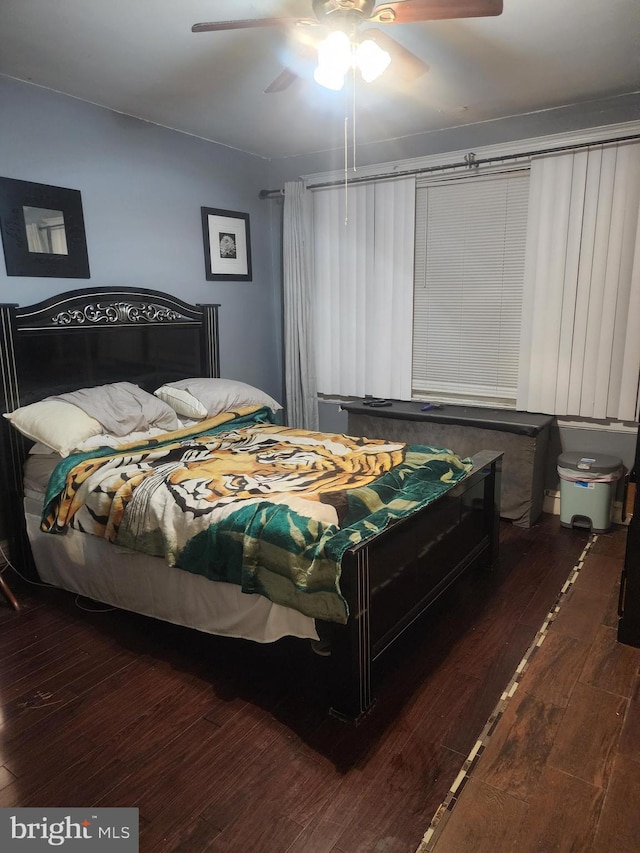 bedroom with dark wood-type flooring and ceiling fan