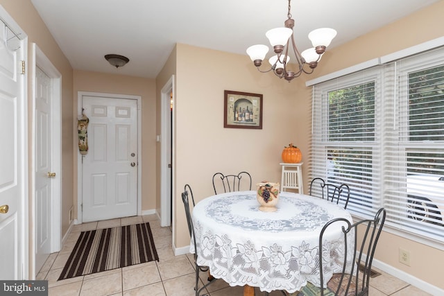 dining area featuring light tile patterned floors and an inviting chandelier