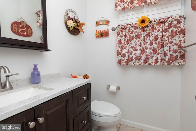 bathroom featuring tile patterned flooring, vanity, and toilet