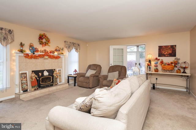 living room featuring a wood stove and light carpet