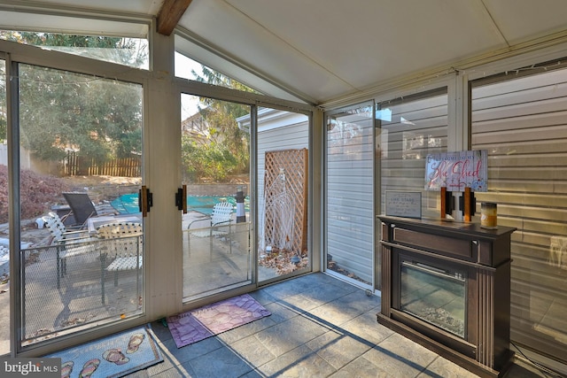 sunroom featuring lofted ceiling with beams