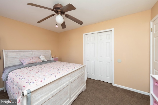 bedroom featuring ceiling fan, a closet, and dark colored carpet