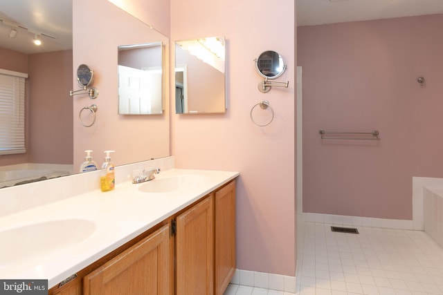 bathroom with vanity, track lighting, tile patterned floors, and a bathing tub