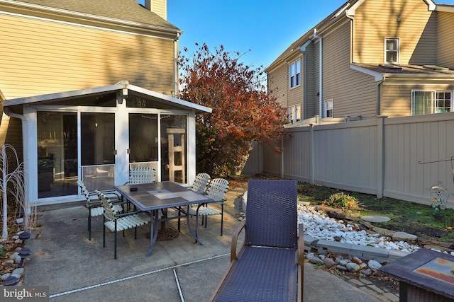 view of patio featuring a sunroom