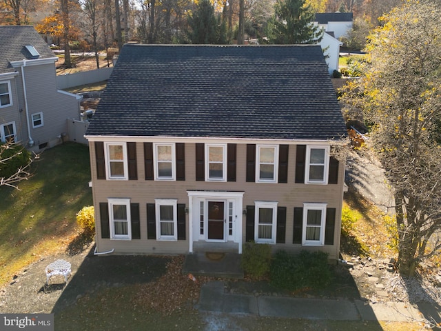 colonial-style house with a front lawn