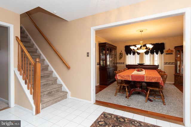 dining room with light tile patterned floors and an inviting chandelier