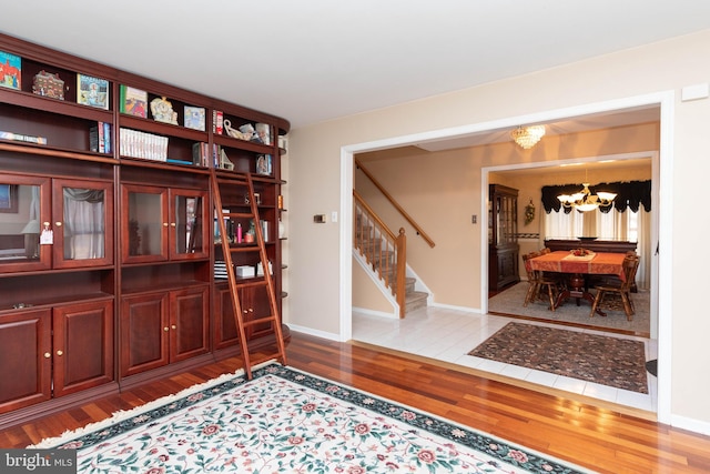 interior space featuring hardwood / wood-style floors and an inviting chandelier