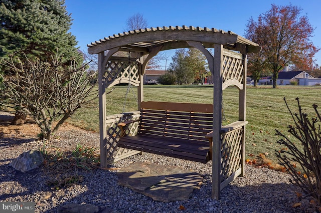 surrounding community featuring a lawn and a pergola