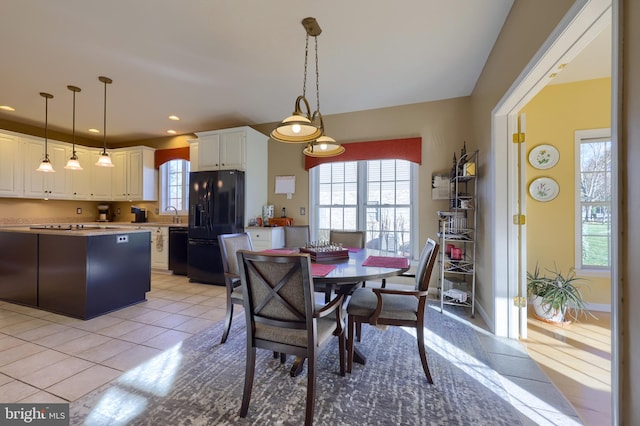 tiled dining space featuring plenty of natural light