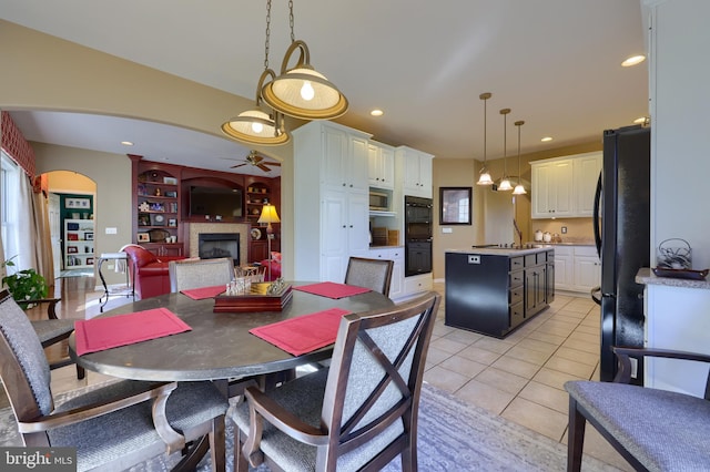 dining space with ceiling fan and light tile patterned floors