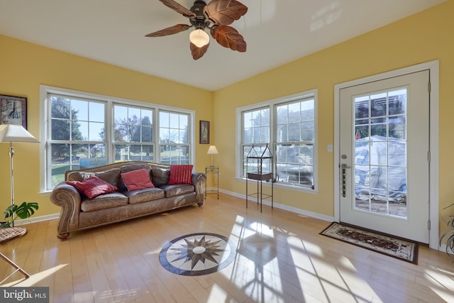 living room featuring light wood-type flooring and ceiling fan