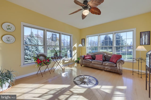 sunroom / solarium with a healthy amount of sunlight and ceiling fan