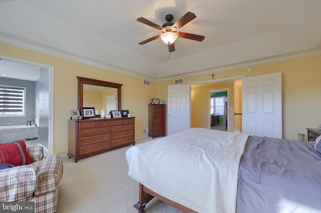 bedroom featuring ceiling fan, ensuite bath, light carpet, and ornamental molding