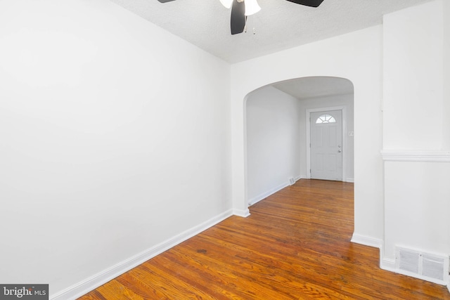 hall featuring dark hardwood / wood-style flooring and a textured ceiling