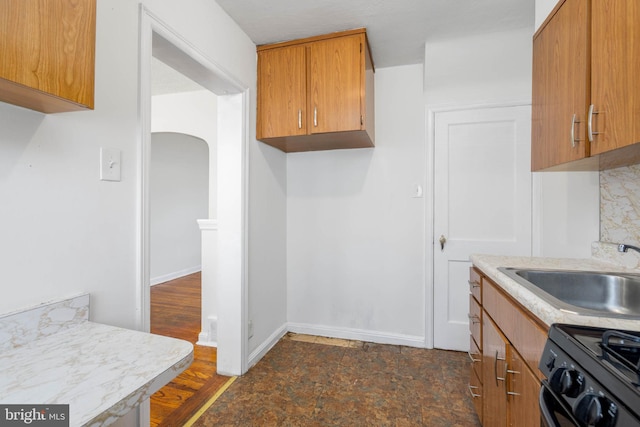 kitchen with black / electric stove and sink