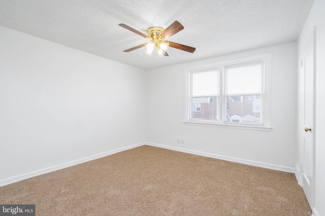 spare room with ceiling fan, carpet floors, and a textured ceiling