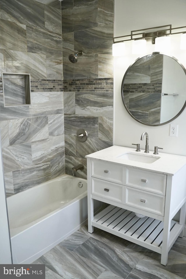 bathroom with vanity and tiled shower / bath