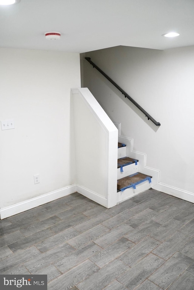 staircase with hardwood / wood-style floors