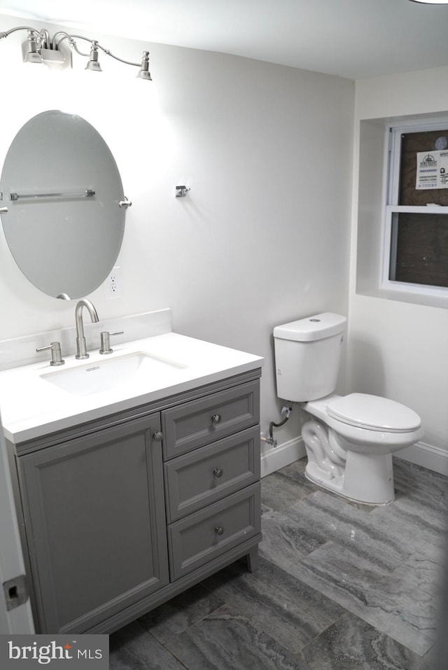 bathroom featuring toilet and vanity