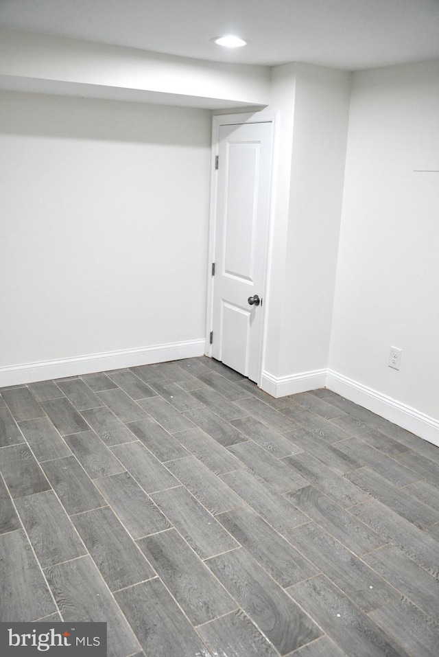 basement with dark hardwood / wood-style flooring