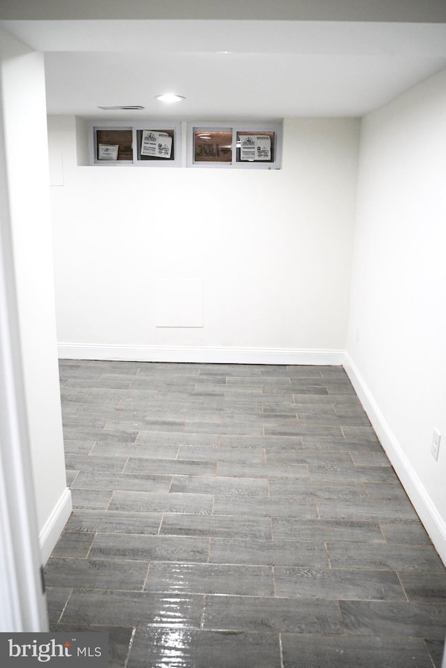 basement featuring dark hardwood / wood-style flooring