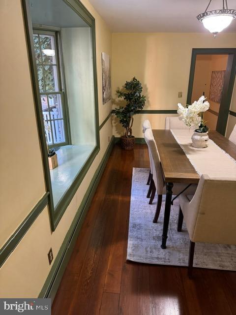 dining room with dark wood-type flooring