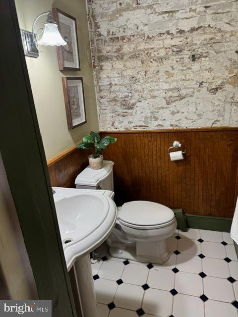28 The Strand, New Castle, DE 19720 - bathroom with toilet, a wainscoted wall, wallpapered walls, and a sink