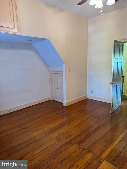 additional living space featuring dark wood-type flooring and ceiling fan