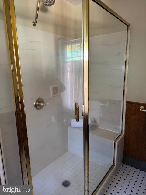 bathroom featuring wood walls and a shower with door