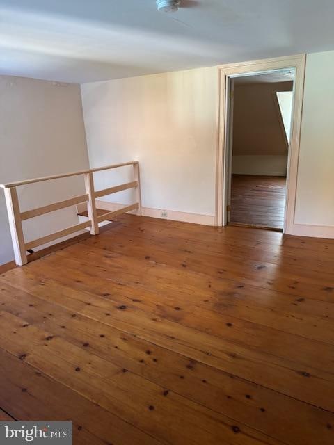 empty room with hardwood / wood-style floors