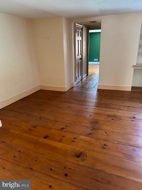 unfurnished room with hardwood / wood-style flooring