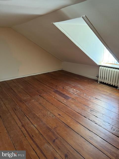 28 The Strand, New Castle, DE 19720 - bonus room with radiator heating unit, hardwood / wood-style floors, and vaulted ceiling