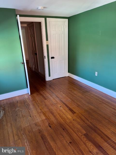 unfurnished bedroom featuring dark wood-type flooring