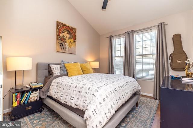 bedroom featuring ceiling fan, dark hardwood / wood-style floors, and vaulted ceiling