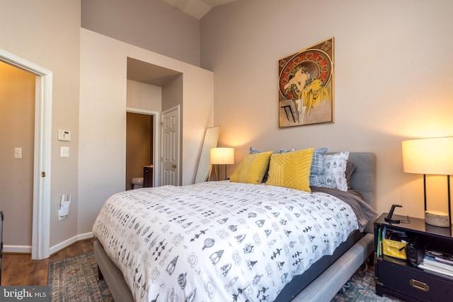 bedroom with dark hardwood / wood-style flooring