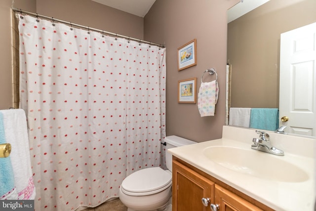 bathroom featuring vanity, a shower with shower curtain, and toilet