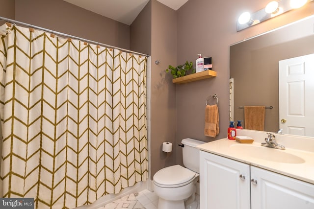 bathroom with toilet, vanity, tile patterned floors, and curtained shower