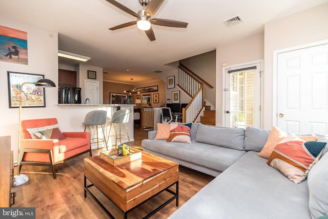 living room with hardwood / wood-style flooring and ceiling fan