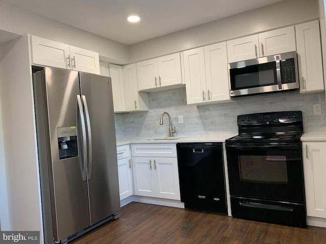 kitchen with white cabinets, black appliances, sink, and dark hardwood / wood-style floors