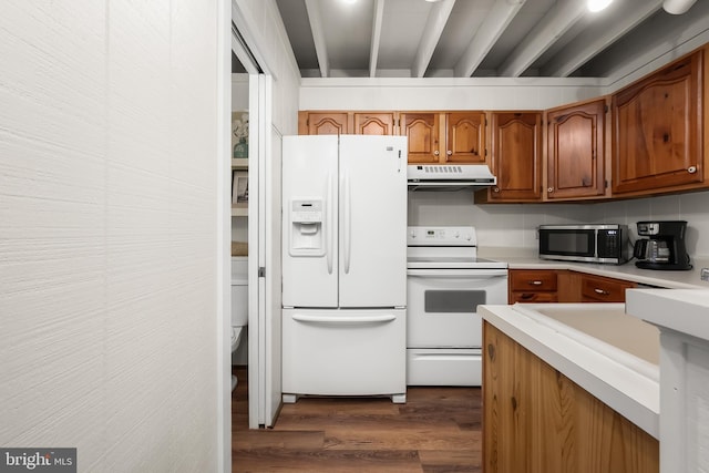 kitchen featuring white appliances and dark hardwood / wood-style floors