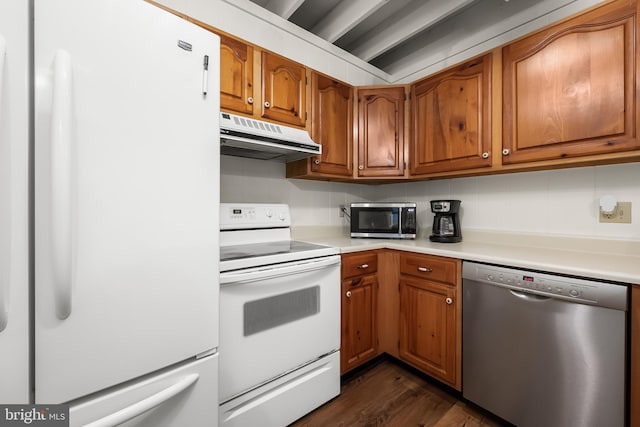 kitchen featuring stainless steel appliances, decorative backsplash, and dark hardwood / wood-style flooring