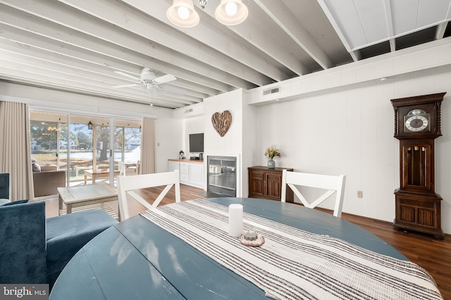 dining area with ceiling fan and dark hardwood / wood-style flooring