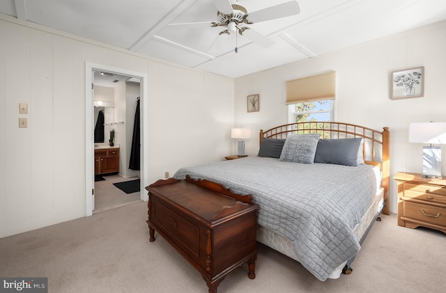 bedroom featuring ceiling fan, connected bathroom, and light colored carpet