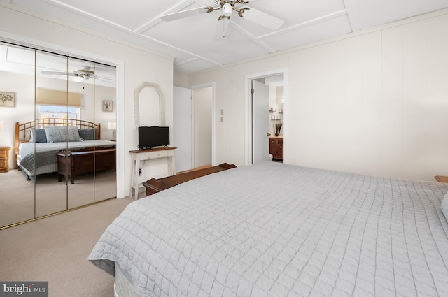 carpeted bedroom featuring ceiling fan and a closet