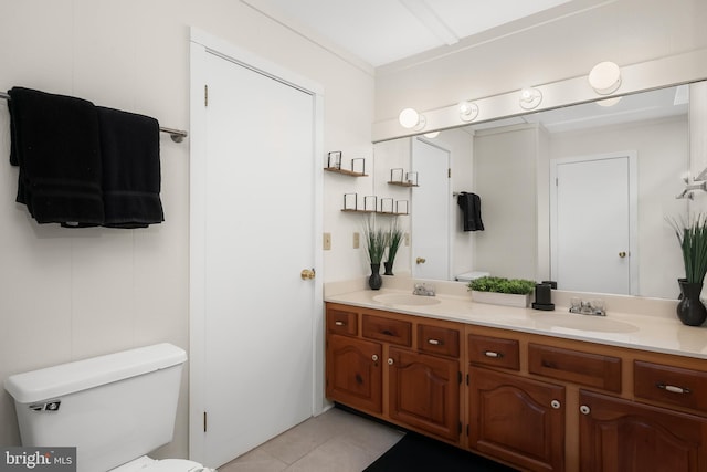 bathroom featuring tile patterned flooring, vanity, and toilet