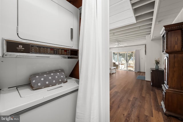 washroom featuring ceiling fan, dark hardwood / wood-style floors, and stacked washer / dryer