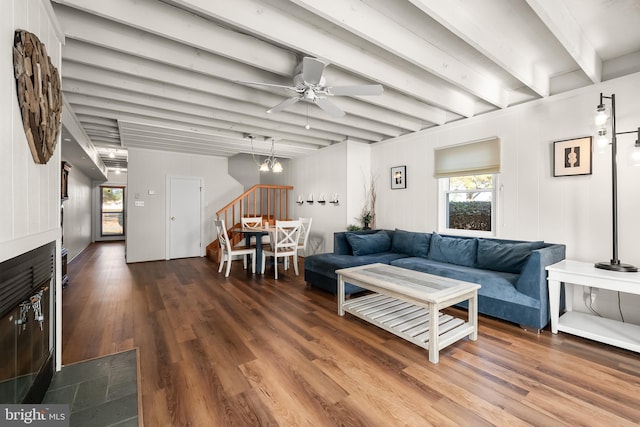 living room featuring hardwood / wood-style floors, ceiling fan, and beam ceiling