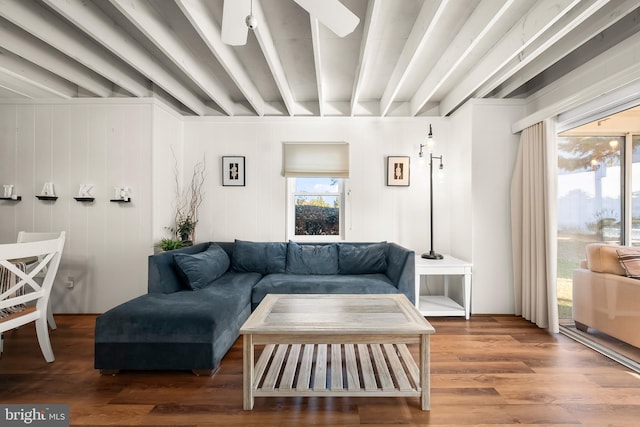 living room featuring hardwood / wood-style flooring, ceiling fan, and beam ceiling