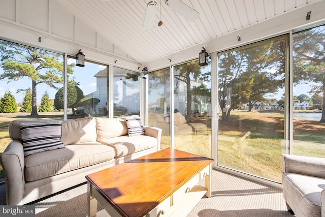 sunroom / solarium featuring ceiling fan, a healthy amount of sunlight, wood ceiling, and vaulted ceiling