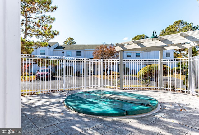 view of swimming pool featuring a patio and a jacuzzi